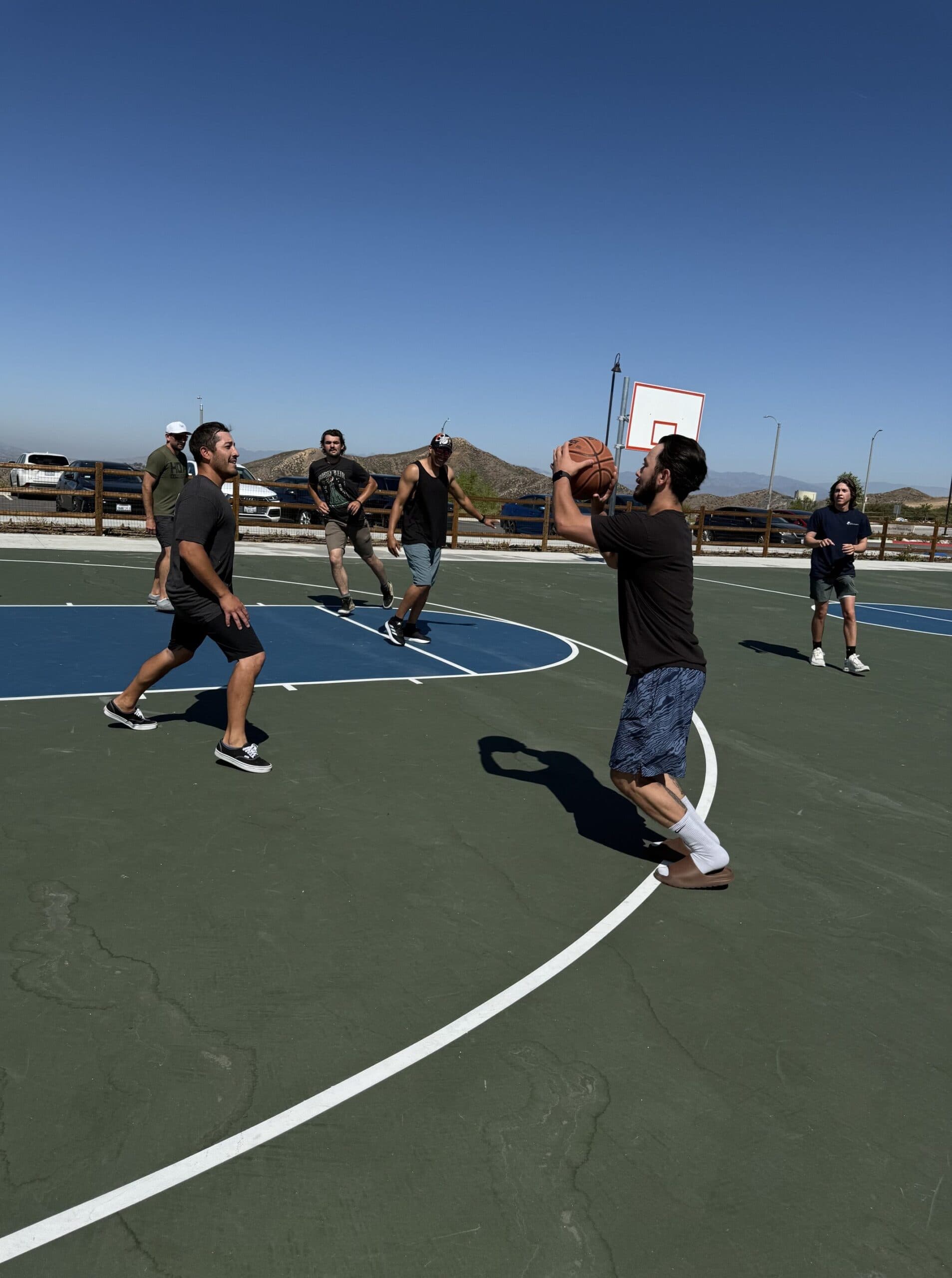 Aspire alumni playing basketball together outdoors