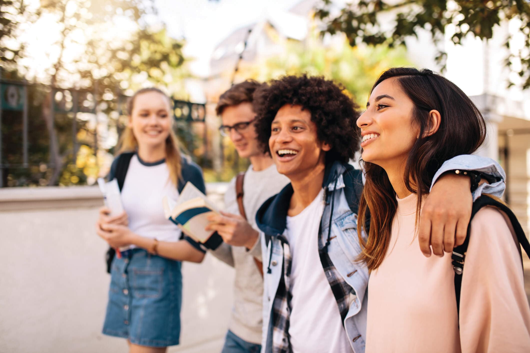Adolescents smiling outdoors together